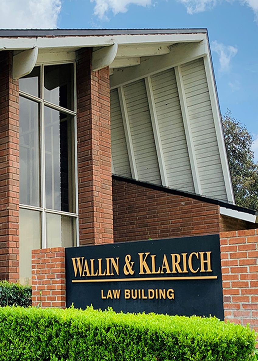 Wallin & Klarich Law Building exterior with brick facade and signage on clear sunny day