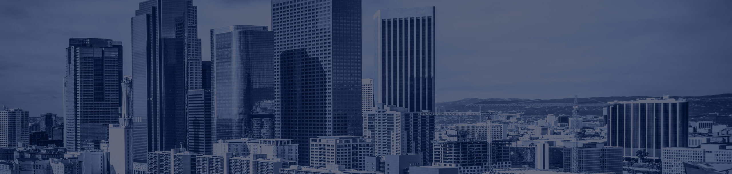 Downtown Los Angeles skyline with tall skyscrapers and cityscape under blue sky