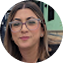 Woman wearing glasses and headphones in professional setting