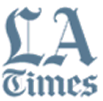 LA Times logo in blue with serif font and decorative flourishes on capital letters