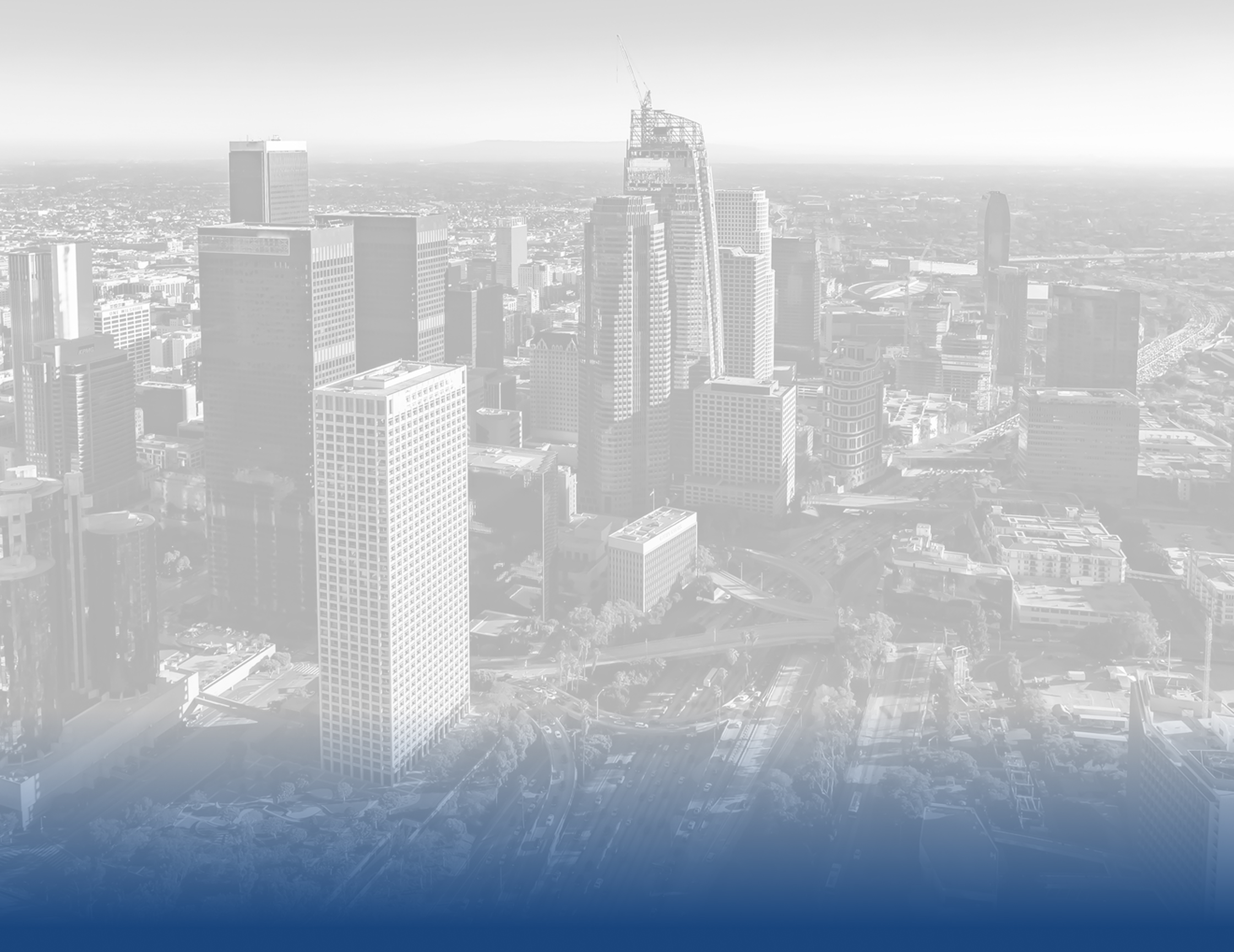 Aerial cityscape view with tall skyscrapers and urban buildings fading into misty sky, blue tint at bottom